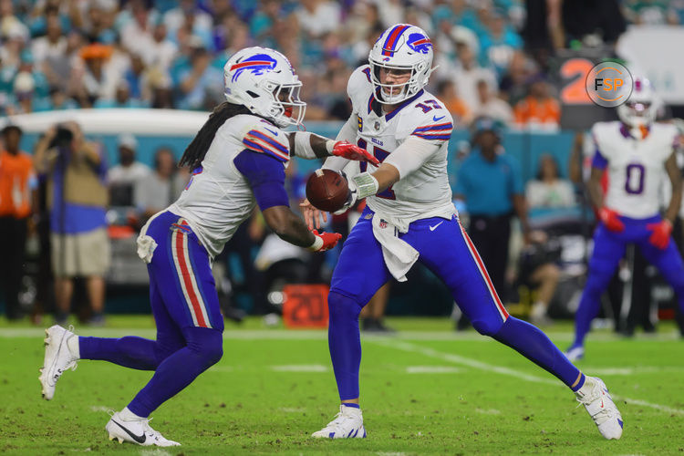 Sep 12, 2024; Miami Gardens, Florida, USA; Buffalo Bills quarterback Josh Allen (17) drops back to handoff the football to running back James Cook (4) during the third quarter at Hard Rock Stadium. Credit: Sam Navarro-Imagn Images