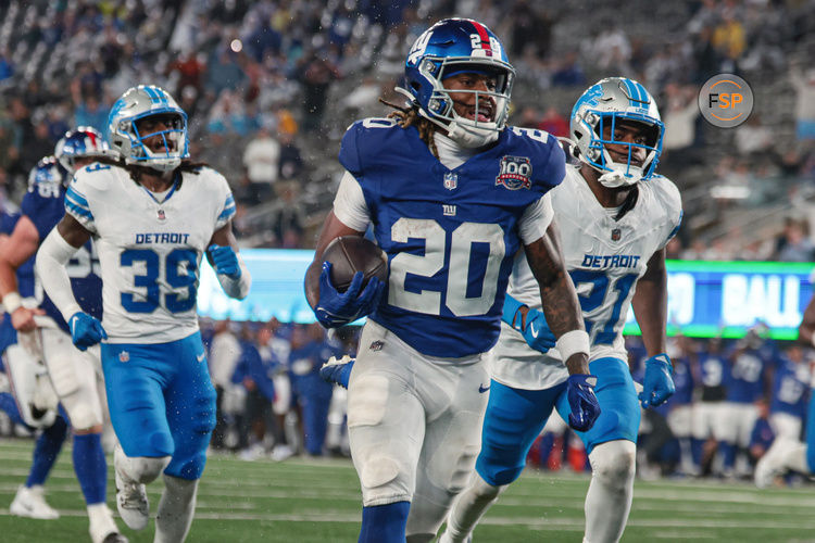 Aug 8, 2024; East Rutherford, New Jersey, USA; New York Giants running back Eric Gray (20) scores a rushing touchdown in front of Detroit Lions cornerback Amik Robertson (21) and cornerback Morice Norris (39) during the first half at MetLife Stadium. Credit: Vincent Carchietta-USA TODAY Sports