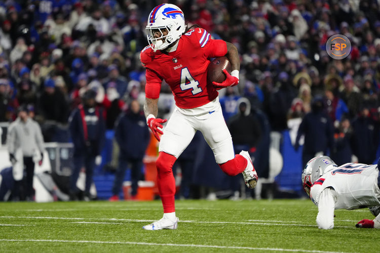 Dec 22, 2024; Orchard Park, New York, USA; Buffalo Bills running back James Cook (4) runs with the ball for a touchdown against the New England Patriots during the first half at Highmark Stadium. Credit: Gregory Fisher-Imagn Images