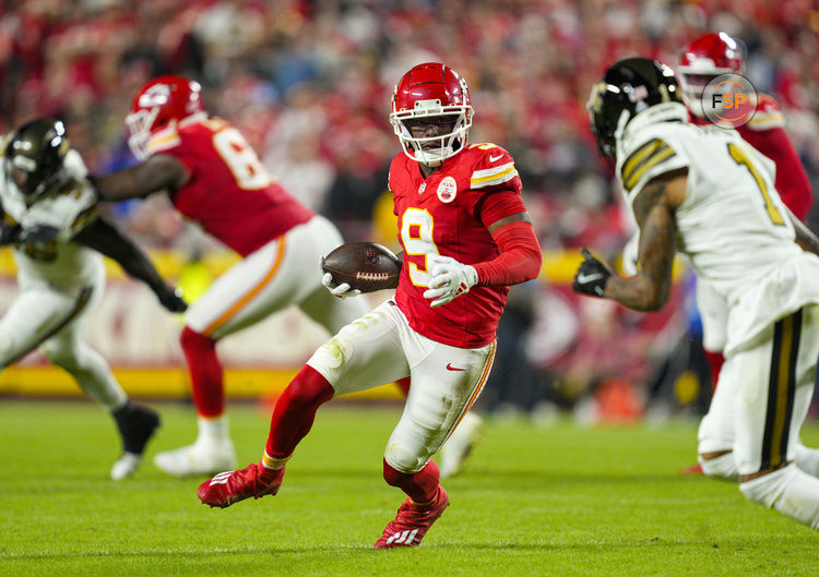Oct 7, 2024; Kansas City, Missouri, USA; Kansas City Chiefs wide receiver JuJu Smith-Schuster (9) runs with the ball against New Orleans Saints cornerback Alontae Taylor (1) during the first half at GEHA Field at Arrowhead Stadium. Credit: Jay Biggerstaff-Imagn Images