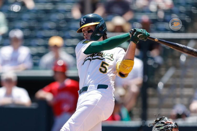 May 22, 2025; West Sacramento, California, USA; Athletics shortstop Jacob Wilson (5) hits a single during the first inning against the Los Angeles Angels at Sutter Health Park. Credit: Sergio Estrada-Imagn Images