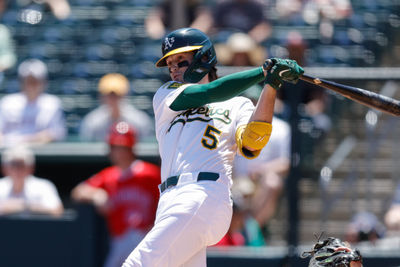 May 22, 2025; West Sacramento, California, USA; Athletics shortstop Jacob Wilson (5) hits a single during the first inning against the Los Angeles Angels at Sutter Health Park. Mandatory Credit: Sergio Estrada-Imagn Images
