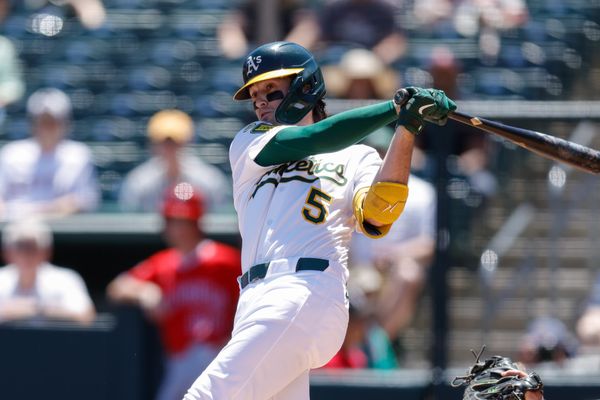 May 22, 2025; West Sacramento, California, USA; Athletics shortstop Jacob Wilson (5) hits a single during the first inning against the Los Angeles Angels at Sutter Health Park. Mandatory Credit: Sergio Estrada-Imagn Images