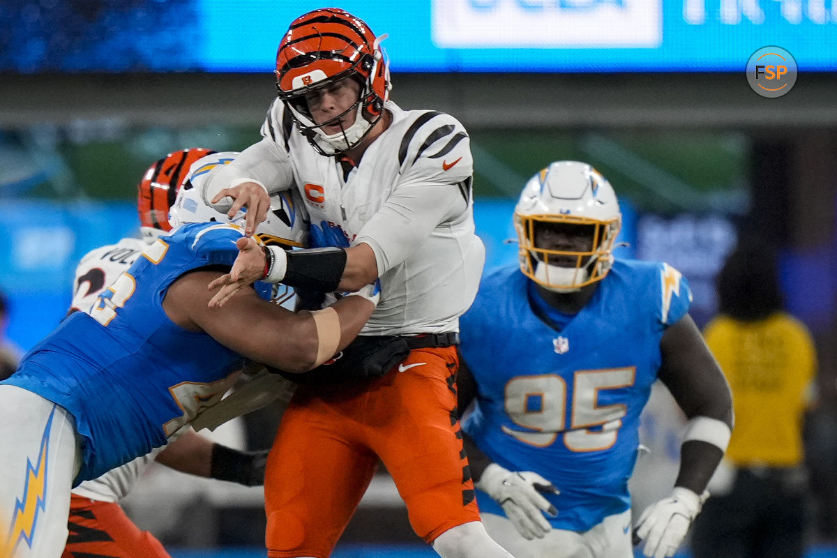 Nov 17, 2024; Inglewood, CA, USA; Cincinnati Bengals quarterback Joe Burrow (9) is hit hard as he throws by Los Angeles Chargers linebacker Tuli Tuipulotu (45) in the fourth quarter at SoFi Stadium. Credit: Sam Greene/USA TODAY Network via Imagn Images 