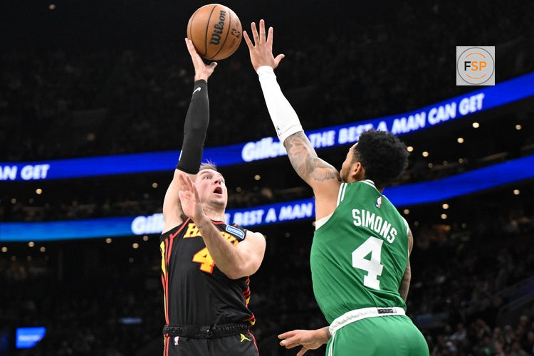 Jan 28, 2026; Boston, Massachusetts, USA; Atlanta Hawks guard Luke Kennard (4) attempts a basket against Boston Celtics guard Anfernee Simons (4) during the first half at the TD Garden. Credit: Brian Fluharty-Imagn Images