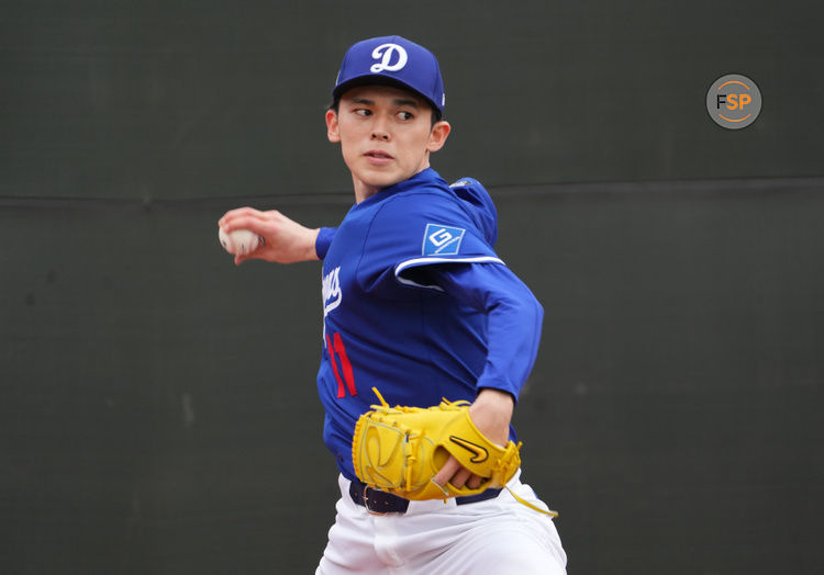 Feb 12, 2025; Glendale, AZ, USA; Los Angeles Dodgers pitcher Roki Sasaki (11) throws during a Spring Training workout at Camelback Ranch. Credit: Joe Camporeale-Imagn Images