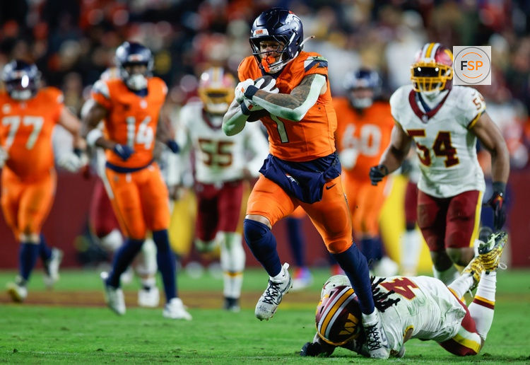 Nov 30, 2025; Landover, Maryland, USA; Denver Broncos tight end Evan Engram (1) avoids a tackle by Washington Commanders linebacker Frankie Luvu (4) in overtime of the game at Northwest Stadium. Credit: Peter Casey-Imagn Images