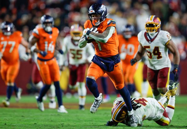 Nov 30, 2025; Landover, Maryland, USA; Denver Broncos tight end Evan Engram (1) avoids a tackle by Washington Commanders linebacker Frankie Luvu (4) in overtime of the game at Northwest Stadium. Mandatory Credit: Peter Casey-Imagn Images