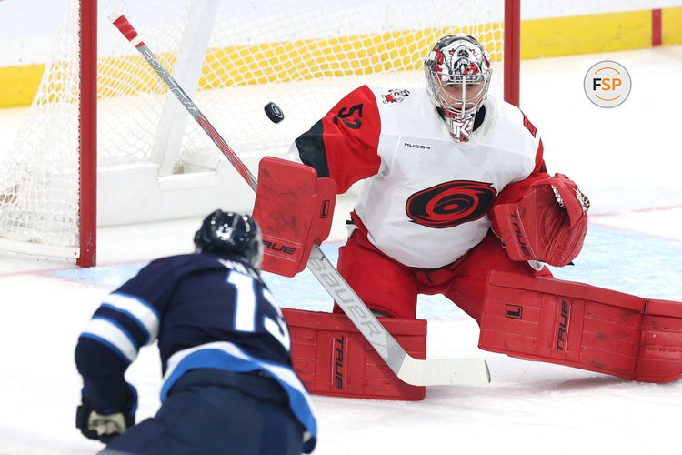 Oct 17, 2026; Winnipeg, Manitoba, CAN;  Carolina Hurricanes goaltender Pyotr Kochetkov (52) eyes a shot from Winnipeg Jets center Gabriel Vilardi (13) in the first period at Canada Life Centre.  Credit: James Carey Lauder-Imagn Images