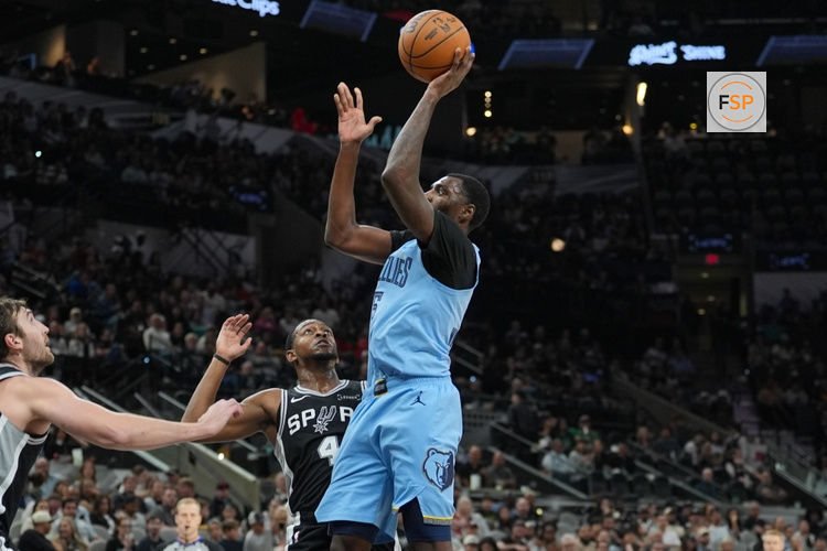 Nov 18, 2025; San Antonio, Texas, USA;  Memphis Grizzlies guard Vince Williams Jr. (5) shoots in front of San Antonio Spurs guard De'Aaron Fox (4) in the second half at Frost Bank Center. Credit: Daniel Dunn-Imagn Images