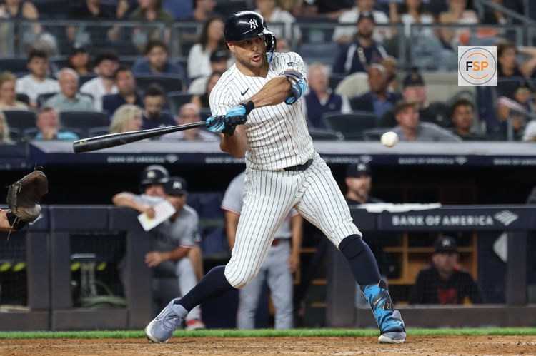 Aug 12, 2025; Bronx, New York, USA; New York Yankees right fielder Giancarlo Stanton (27) hits a two-run single during the seventh inning against the Minnesota Twins at Yankee Stadium. Credit: Vincent Carchietta-Imagn Images