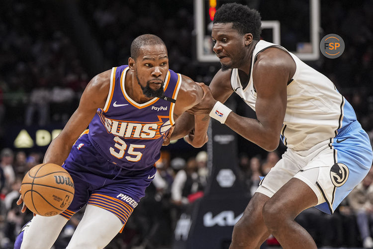 Jan 14, 2025; Atlanta, Georgia, USA; Phoenix Suns forward Kevin Durant (35) is defended by Atlanta Hawks center Clint Capela (15) during the second half at State Farm Arena. Credit: Dale Zanine-Imagn Images