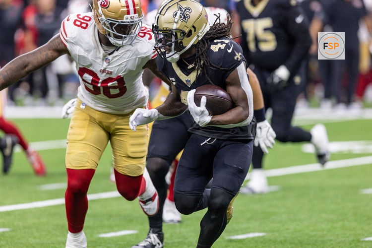 Sep 14, 2025; New Orleans, Louisiana, USA;  San Francisco 49ers defensive end Mykel Williams (98) tackles New Orleans Saints running back Alvin Kamara (41) during the second half at Caesars Superdome. Credit: Stephen Lew-Imagn Images