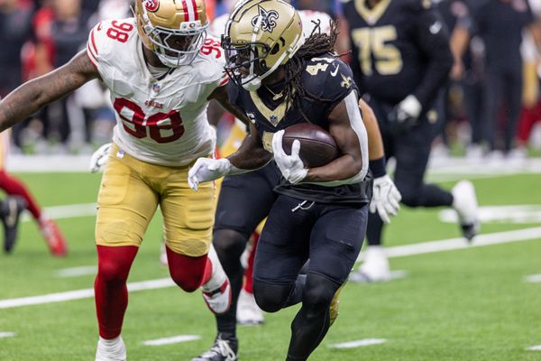 Sep 14, 2025; New Orleans, Louisiana, USA;  San Francisco 49ers defensive end Mykel Williams (98) tackles New Orleans Saints running back Alvin Kamara (41) during the second half at Caesars Superdome. Mandatory Credit: Stephen Lew-Imagn Images