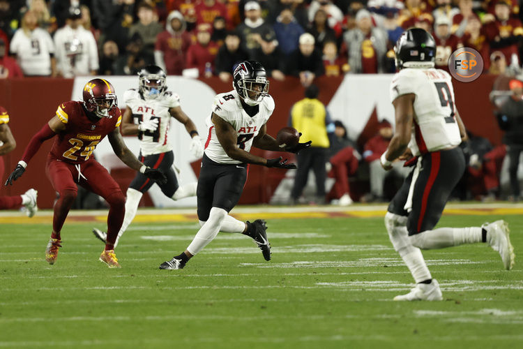 Dec 29, 2024; Landover, Maryland, USA; Atlanta Falcons tight end Kyle Pitts (8) catches a pass from Falcons quarterback Michael Penix Jr. (9) as Washington Commanders cornerback Michael Davis (24) defends during the fourth quarter at Northwest Stadium. Credit: Geoff Burke-Imagn Images