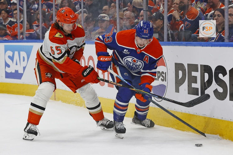 Apr 22, 2026; Edmonton, Alberta, CAN; Edmonton Oilers forward Ryan Nugent-Hopkins (93) and Anaheim Ducks defensemen Jacob Trouba (65) battle along the boards for a loose puck  during the first period in game two of the first round of the 2026 Stanley Cup Playoffs at Rogers Place. Credit: Perry Nelson-Imagn Images