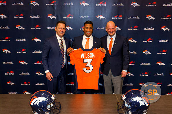 ENGLEWOOD, CO - MARCH 16:  Quarterback Russell Wilson #3 of the Denver Broncos poses with his jersey alongside (L) General Manager George Paton and Head Coach Nathaniel Hackett following an introductory press conference at UCHealth Training Center on March 16, 2022 in Englewood, Colorado. (Photo by Justin Edmonds/Getty Images)