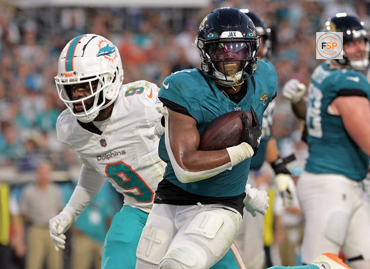 Aug 26, 2023; Jacksonville, Florida, USA; Jacksonville Jaguars running back Travis Etienne (1) runs for a touchdown during the first half against the Miami Dolphins at EverBank Stadium. Credit: Melina Myers-USA TODAY Sports
