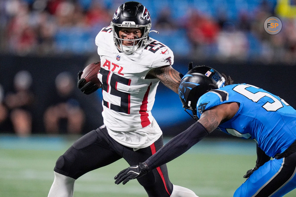 Oct 13, 2024; Charlotte, North Carolina, USA; Atlanta Falcons running back Tyler Allgeier (25) stiff arms Carolina Panthers linebacker Claudin Cherelus (53) during the second half at Bank of America Stadium. Credit: Jim Dedmon-Imagn Images