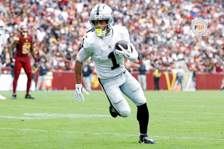Sep 21, 2025; Landover, Maryland, USA; Las Vegas Raiders wide receiver Tre Tucker (1) runs a touchdown pass during the second half against the Washington Commanders at Northwest Stadium. Credit: Amber Searls-Imagn Images