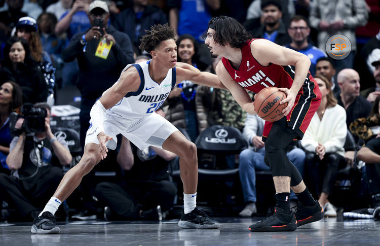 Feb 13, 2025; Dallas, Texas, USA;  Miami Heat guard Jaime Jaquez Jr. (11) controls the ball as Dallas Mavericks forward Kessler Edwards (20) defends during the first quarter at American Airlines Center. Credit: Kevin Jairaj-Imagn Images