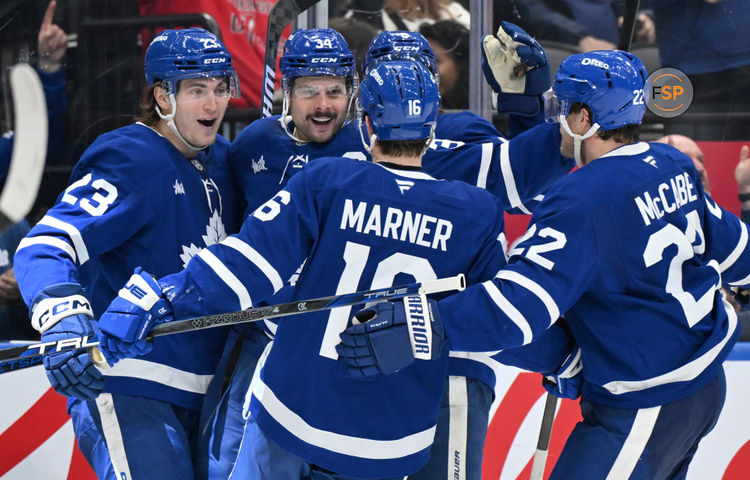 Jan 16, 2025; Toronto, Ontario, CAN;  Toronto Maple Leafs forward Auston Matthews (34) celebrates with forwards Matthew Knies (23) and Mitch Marner (16) and defenseman Jake McCabe (22) after scoring a goal against the New Jersey Devils in the third period at Scotiabank Arena. Credit: Dan Hamilton-Imagn Images