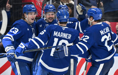 Jan 16, 2025; Toronto, Ontario, CAN;  Toronto Maple Leafs forward Auston Matthews (34) celebrates with forwards Matthew Knies (23) and Mitch Marner (16) and defenseman Jake McCabe (22) after scoring a goal against the New Jersey Devils in the third period at Scotiabank Arena. Mandatory Credit: Dan Hamilton-Imagn Images