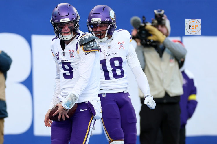 Dec 21, 2025; East Rutherford, New Jersey, USA; Minnesota Vikings quarterback J.J. McCarthy (9) reacts with wide receiver Justin Jefferson (18) after rushing for a touchdown against the New York Giants during the first half at MetLife Stadium. Credit: Vincent Carchietta-Imagn Images