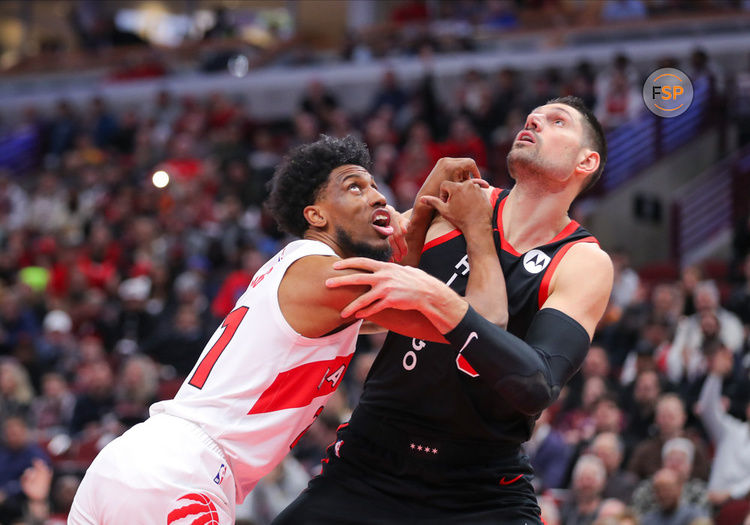 CHICAGO, IL - JANUARY 30: Thaddeus Young #21 of the Toronto Raptors box out Nikola Vucevic #9 of the Chicago Bulls during the first half against at the United Center on January 30, 2024 in Chicago, Illinois. (Photo by Melissa Tamez/Icon Sportswire)