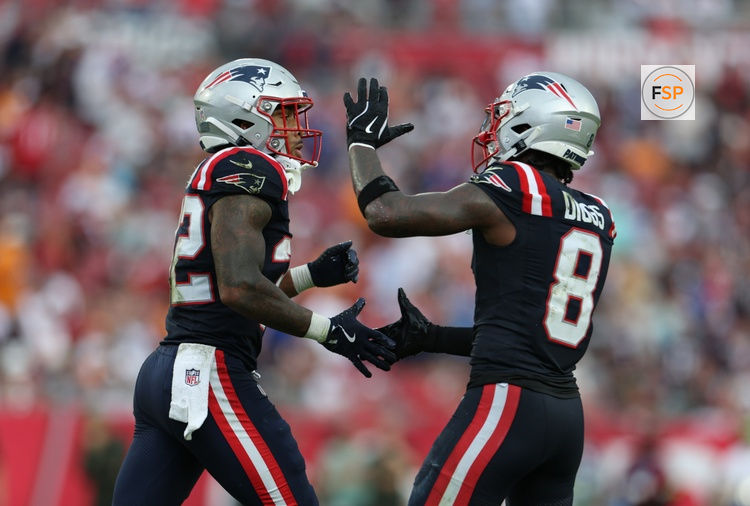 Nov 9, 2025; Tampa, Florida, USA; New England Patriots running back Treveyon Henderson (32) and wide receiver Stefon Diggs (8) celebrate a touchdown during the third quarter against the Tampa Bay Buccaneers at Raymond James Stadium. Credit: Nathan Ray Seebeck-Imagn Images