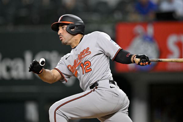 Jun 30, 2025; Arlington, Texas, USA; Baltimore Orioles right fielder Ramon Laureano (12) hits a double and drives in a run during the eleventh inning against the Texas Rangers at Globe Life Field. Mandatory Credit: Jerome Miron-Imagn Images