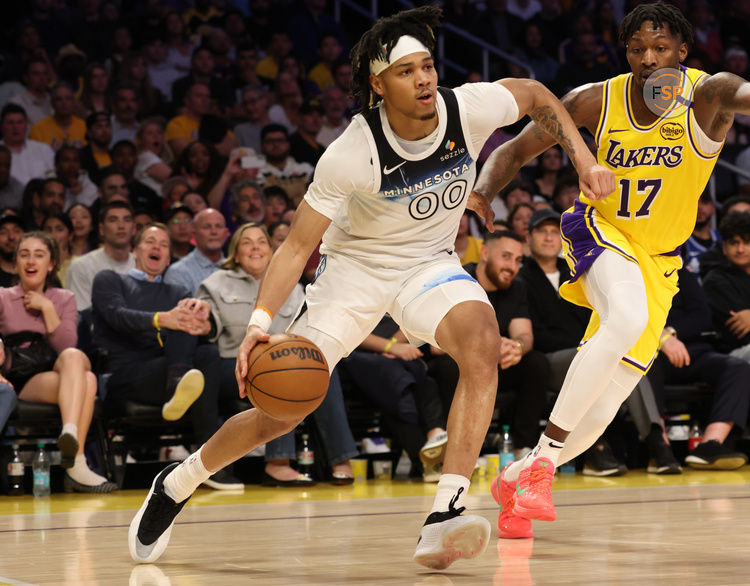 Feb 27, 2025; Los Angeles, California, USA; Minnesota Timberwolves guard Terrence Shannon Jr. (00) drives against Los Angeles Lakers forward Dorian Finney-Smith (17) during the third quarter at Crypto.com Arena. Credit: Jason Parkhurst-Imagn Images