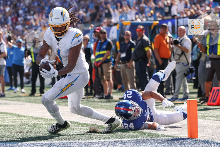 Sep 28, 2025; East Rutherford, New Jersey, USA; Los Angeles Chargers wide receiver Quentin Johnston (1) scores on a touchdown reception during the second quarter against New York Giants safety Dane Belton (24) at MetLife Stadium. Credit: Vincent Carchietta-Imagn Images