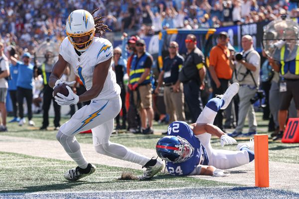 Sep 28, 2025; East Rutherford, New Jersey, USA; Los Angeles Chargers wide receiver Quentin Johnston (1) scores on a touchdown reception during the second quarter against New York Giants safety Dane Belton (24) at MetLife Stadium. Mandatory Credit: Vincent Carchietta-Imagn Images