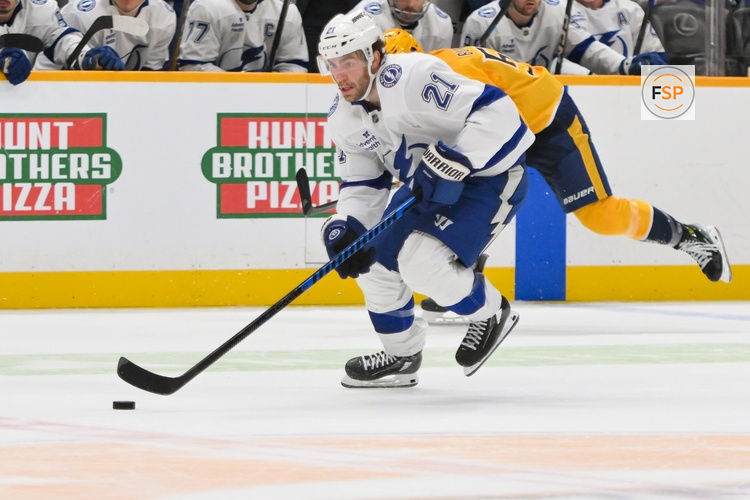 Oct 28, 2025; Nashville, Tennessee, USA;  Tampa Bay Lightning center Brayden Point (21) skates with the puck against the Nashville Predators during the second period at Bridgestone Arena. Credit: Steve Roberts-Imagn Images