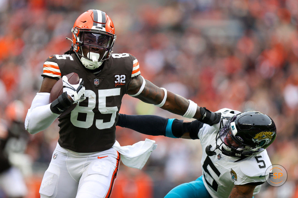 CLEVELAND, OH - DECEMBER 10: Cleveland Browns tight end David Njoku (85) gives a stiff-arm to Jacksonville Jaguars safety Andre Cisco (5) as he scores on a 30-yard touchdown catch during the second quarter of the National Football League game between the Jacksonville Jaguars and Cleveland Browns on December 10, 2023, at Cleveland Browns Stadium in Cleveland, OH. (Photo by Frank Jansky/Icon Sportswire)