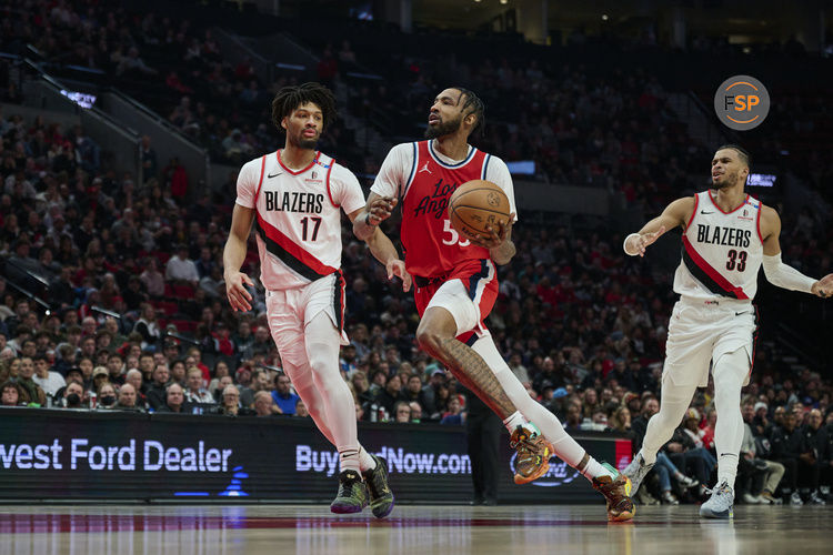 Jan 16, 2025; Portland, Oregon, USA; LA Clippers forward Derrick Jones Jr. (55) drives to the basket during the first half against Portland Trail Blazers guard Shaedon Sharpe (17) at Moda Center. Credit: Troy Wayrynen-Imagn Images