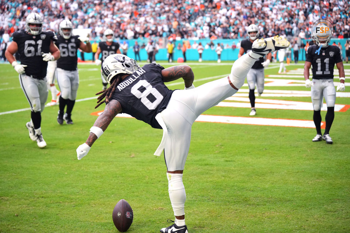 Nov 17, 2024; Miami Gardens, Florida, USA; Las Vegas Raiders running back Ameer Abdullah (8) celebrates a touchdown against the Miami Dolphins in the fourth quarter with a roundhouse kick at Hard Rock Stadium. Credit: Jim Rassol-Imagn Images