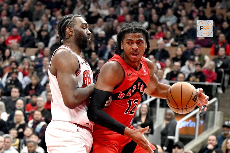 Feb 5, 2026; Toronto, Ontario, CAN; Toronto Raptors forward Collin Murray-Boyles (12) dribbles against Chicago Bulls forward Patrick Williams (44) in the first half at Scotiabank Arena. Credit: Dan Hamilton-Imagn Images