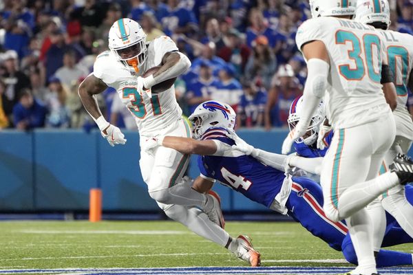 Sep 18, 2025; Orchard Park, New York, USA; Buffalo Bills safety Cole Bishop (24) tackles Miami Dolphins running back Ollie Gordon II (31) in the fourth quarter at Highmark Stadium. Mandatory Credit: Gregory Fisher-Imagn Images