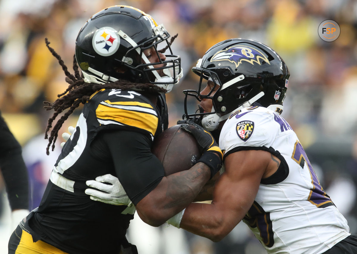 Nov 17, 2024; Pittsburgh, Pennsylvania, USA;  Pittsburgh Steelers running back Najee Harris (22) carries the ball against Baltimore Ravens safety Ar'Darius Washington (29) during the fourth quarter at Acrisure Stadium. Credit: Charles LeClaire-Imagn Images