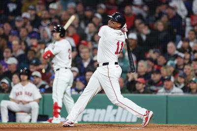 May 20, 2025; Boston, Massachusetts, USA; Boston Red Sox designated hitter Rafael Devers (11) hits a solo home run during the fifth inning against the New York Mets at Fenway Park. Mandatory Credit: Paul Rutherford-Imagn Images