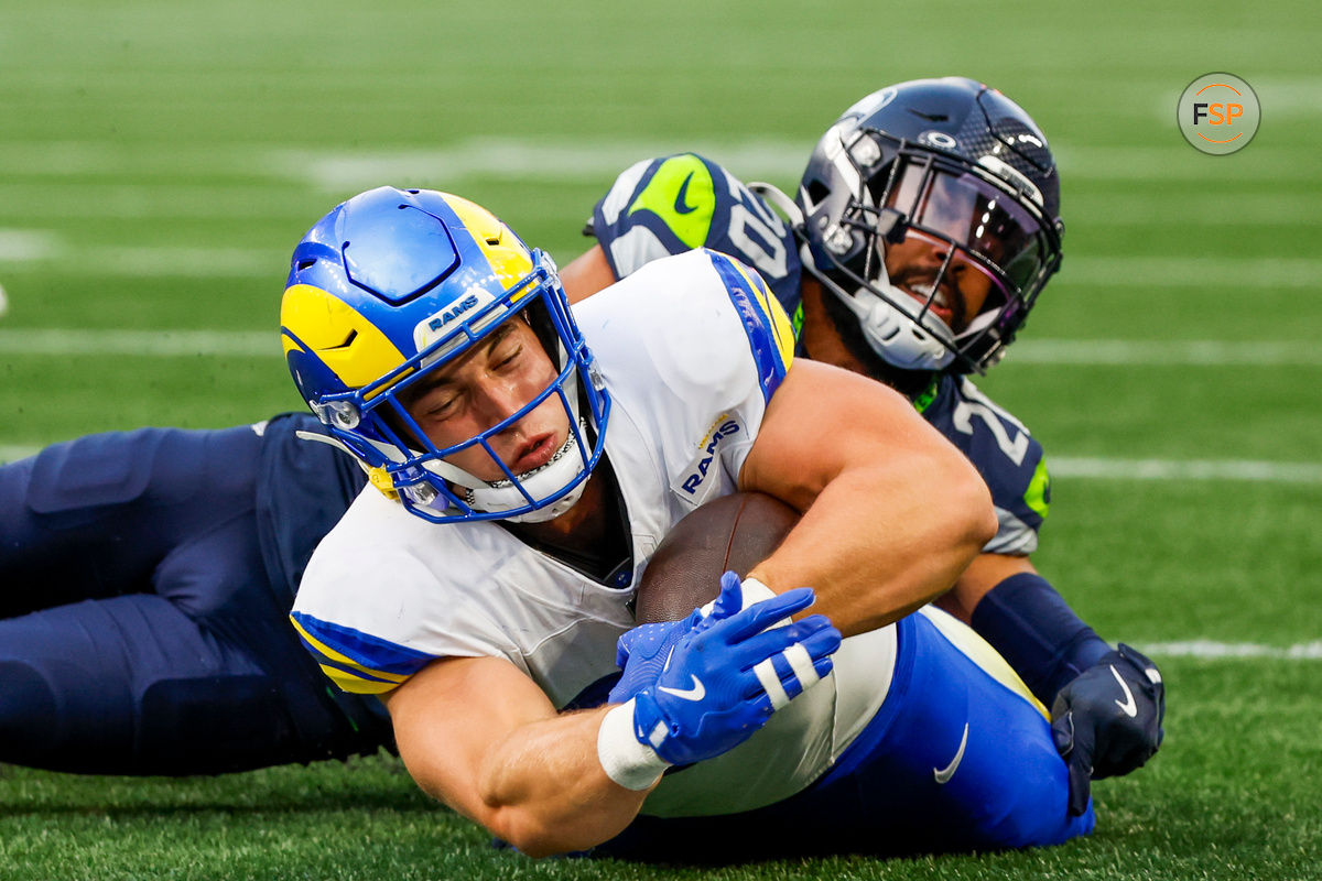 Nov 3, 2024; Seattle, Washington, USA; Los Angeles Rams tight end Davis Allen (87) is tackled by Seattle Seahawks safety Julian Love (20) during the third quarter at Lumen Field. Credit: Joe Nicholson-Imagn Images