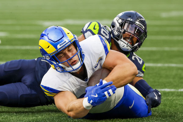 Nov 3, 2024; Seattle, Washington, USA; Los Angeles Rams tight end Davis Allen (87) is tackled by Seattle Seahawks safety Julian Love (20) during the third quarter at Lumen Field. Mandatory Credit: Joe Nicholson-Imagn Images