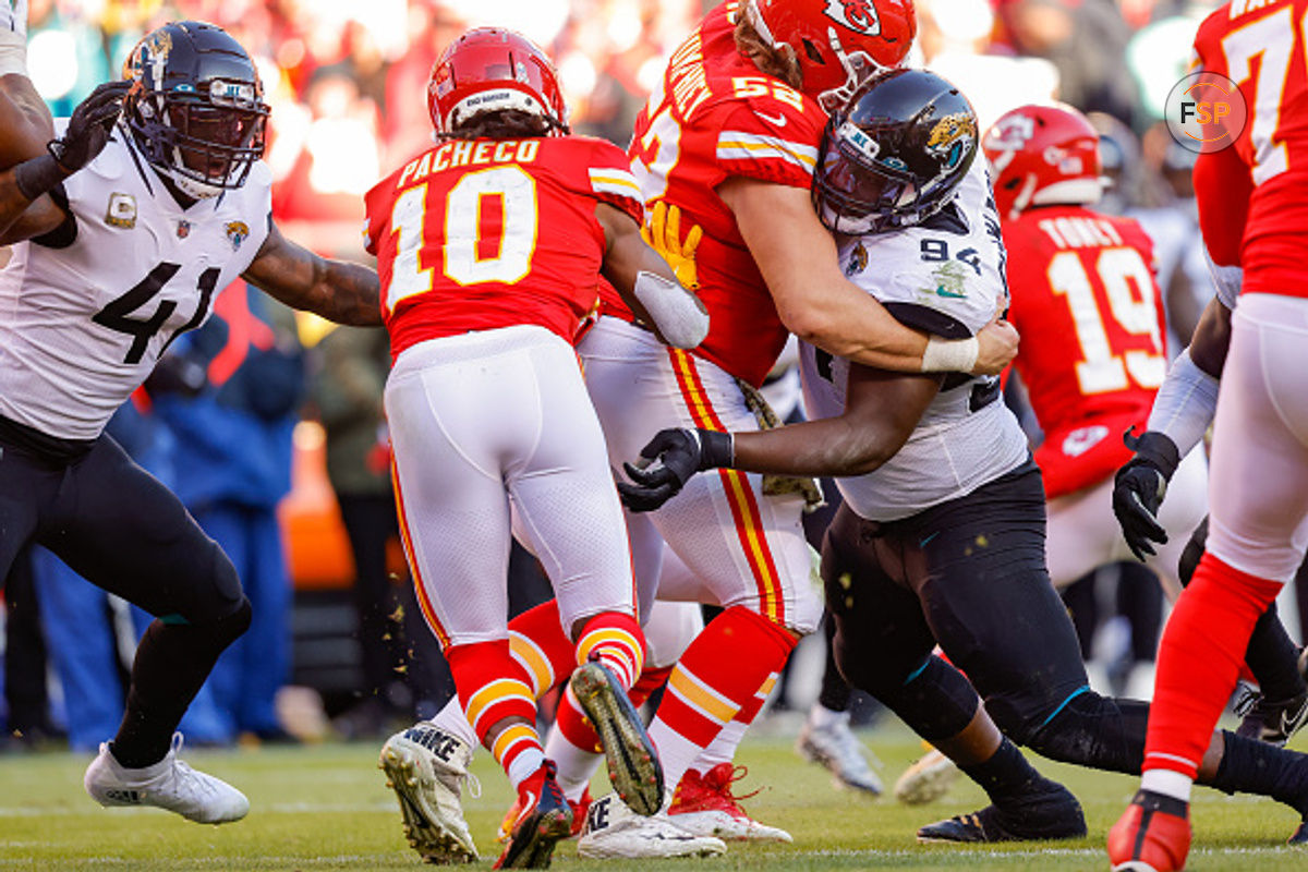 KANSAS CITY, MO - NOVEMBER 13: Folorunso Fatukasi #94 of the Jacksonville Jaguars reaches for Isiah Pacheco #10 of the Kansas City Chiefs during a fourth quarter run at Arrowhead Stadium on November 13, 2022 in Kansas City, Missouri. (Photo by David Eulitt/Getty Images)