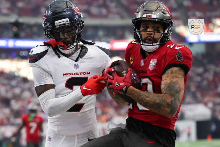Sep 15, 2025; Houston, Texas, USA; Tampa Bay Buccaneers wide receiver Mike Evans (13) makes a catch as Houston Texans safety Calen Bullock (2) defends during the first quarter at NRG Stadium. Credit: Thomas Shea-Imagn Images