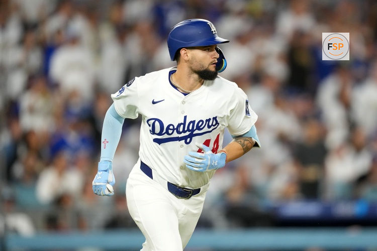 Jun 18, 2025; Los Angeles, California, USA; Los Angeles Dodgers left fielder Andy Pages (44) hits a RBI sacrifice fly in the fifth inning against the San Diego Padres at Dodger Stadium. Credit: Kirby Lee-Imagn Images