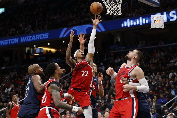 Jan 19, 2026; Washington, District of Columbia, USA; LA Clippers guard Jordan Miller (22) shoots the ball in front of Washington Wizards forward Kyshawn George (18) in the second half at Capital One Arena. Credit: Geoff Burke-Imagn Images