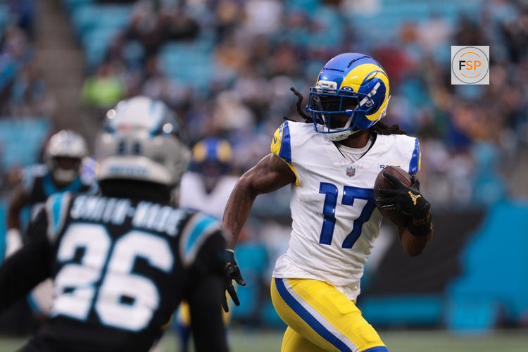 Nov 30, 2025; Charlotte, North Carolina, USA; Los Angeles Rams wide receiver Davante Adams (17) runs after making a catch as Carolina Panthers cornerback Chau Smith-Wade (26) defends during the first quarter at Bank of America Stadium. Credit: Scott Kinser-Imagn Images