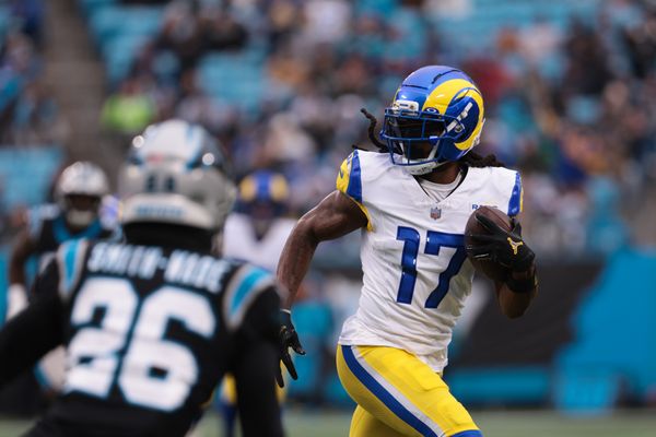 Nov 30, 2025; Charlotte, North Carolina, USA; Los Angeles Rams wide receiver Davante Adams (17) runs after making a catch as Carolina Panthers cornerback Chau Smith-Wade (26) defends during the first quarter at Bank of America Stadium. Mandatory Credit: Scott Kinser-Imagn Images